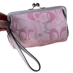 Coach Kiss Lock clutch with detachable wrist strap.